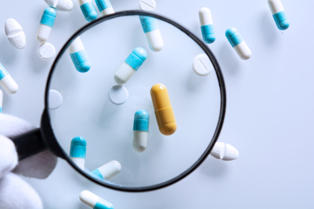 suspicious medications under a magnifying glass